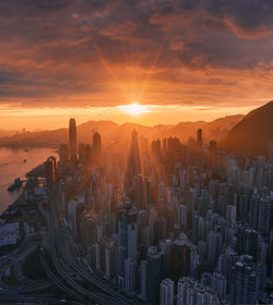 Aerial view of central district in hong kong against sky during sunrise