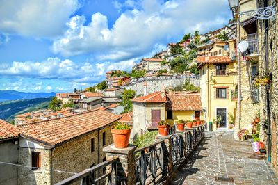 Houses against cloudy sky