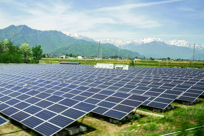 Scenic view of field and mountains against sky