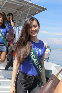 Portrait of a smiling young woman in boat