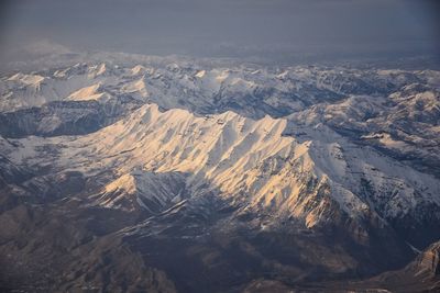 Wasatch front rocky mountain range aerial snow capped peaks winter urban salt lake city utah usa