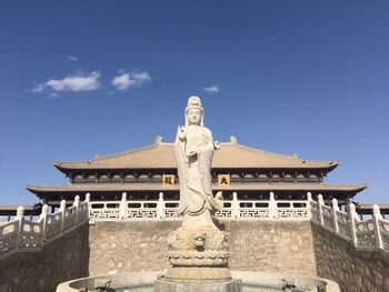 Low angle view of statue against sky