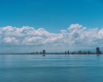 Scenic view of sea and buildings against sky