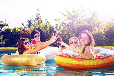 Portrait of happy friends in swimming pool