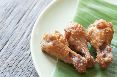 High angle view of fried chicken in plate on table