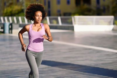 Young woman jogging on street