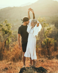 A couple is dancing in the morning light.