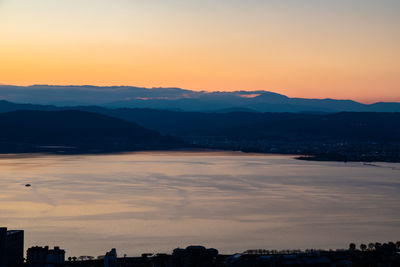 Scenic view of silhouette mountains against sky during sunset