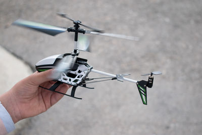 Child playing with radio-controlled helicopter.