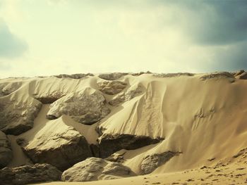 Scenic view of landscape against cloudy sky