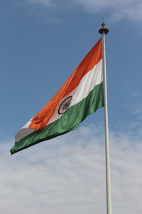 Low angle view of indian flag waving against sky