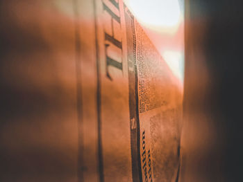 Close-up of text on glass at sunset