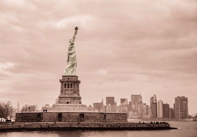 Low angle view of statue of liberty against sky