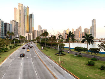 View of city street and buildings against sky