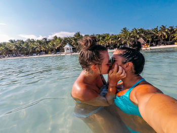 Smiling couple kissing in sea