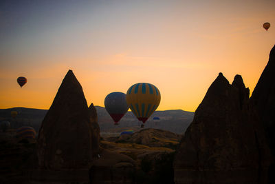 Hot air balloons against sky during sunset