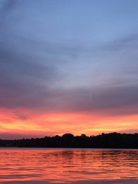 Scenic view of lake against romantic sky at sunset