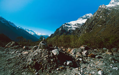 Scenic view of snowcapped mountains against blue sky