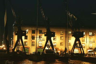 Illuminated commercial dock against sky at night