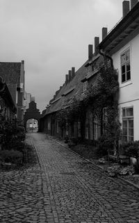 Empty alley amidst buildings in city