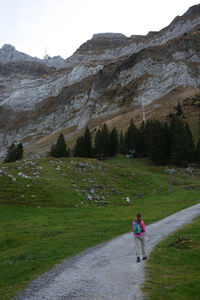 Rear view of people walking on mountain