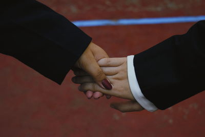 Two women holding hands while taking a walk