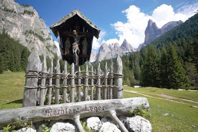 Built structure by mountains against sky