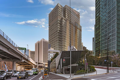 Street amidst buildings against sky in city