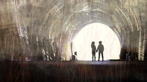 Silhouette men in corridor