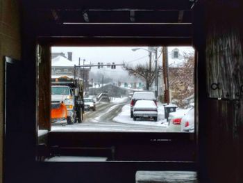 Cars on road seen through wet window