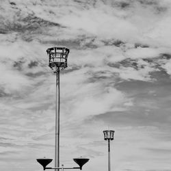 Low angle view of flood lights against sky