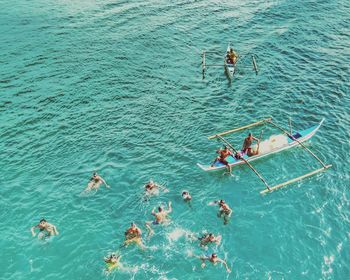 High angle view of people enjoying in sea