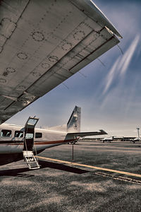 Low angle view of airplane flying against sky