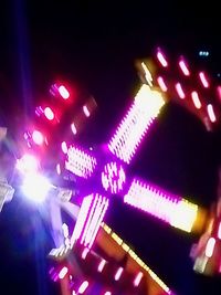 Low angle view of illuminated lighting equipment at night