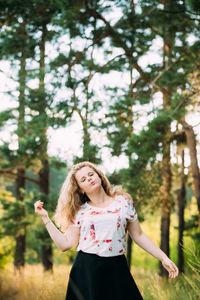 Woman standing in forest