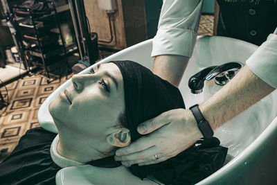 Side view of man holding hands