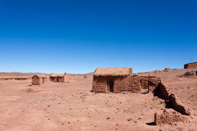 Scenic view of desert against clear blue sky