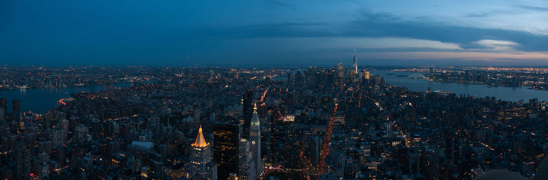 High angle view of city lit up at dusk