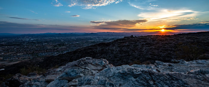 Scenic view of rocks against sky during sunset