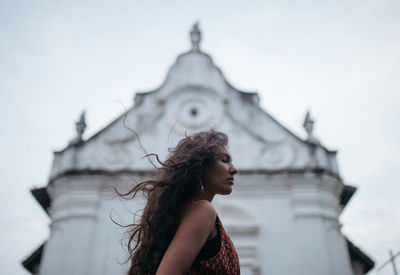 Low angle view of woman standing against building