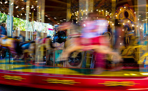 Blurred motion of illuminated carousel at amusement park
