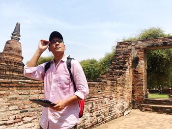 Man with digital tablet walking in historic building