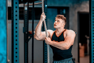 Portrait of young woman exercising in gym