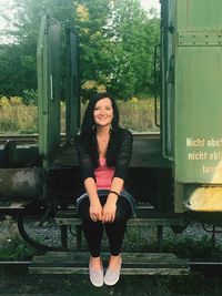 Portrait of smiling woman sitting on seat