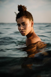 Portrait of man swimming in sea against sky