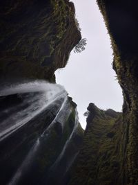 Scenic view of waterfall against sky