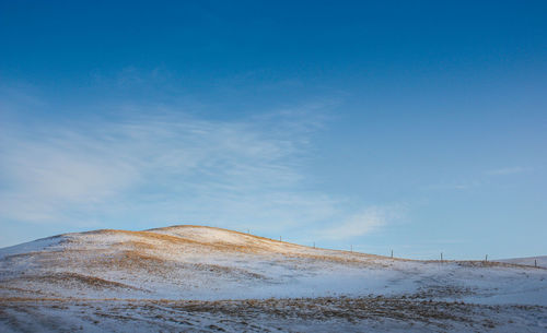 Scenic view of mountain against blue sky