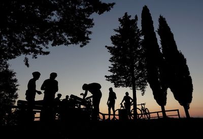 Silhouette people against sky during sunset