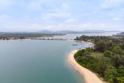 Scenic view of sea by buildings against sky