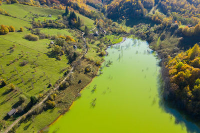 Aerial view of green mine waters from a copper mine flooding natural habitat. geamana, romania